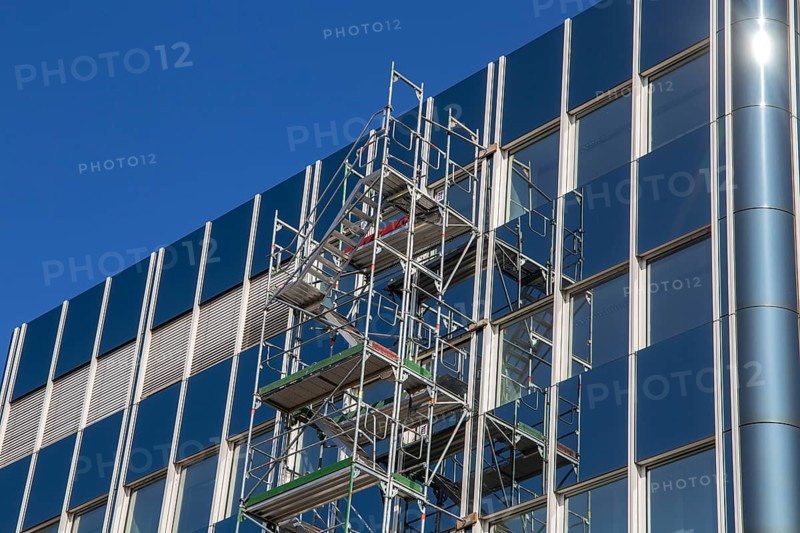 Steel scaffolding on the large glass façade of an office building