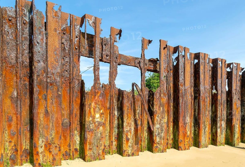 Old rusty broken steel sheet piling sea wall coastal defence, River Deben, Bawdsey, Suffolk, England, UK