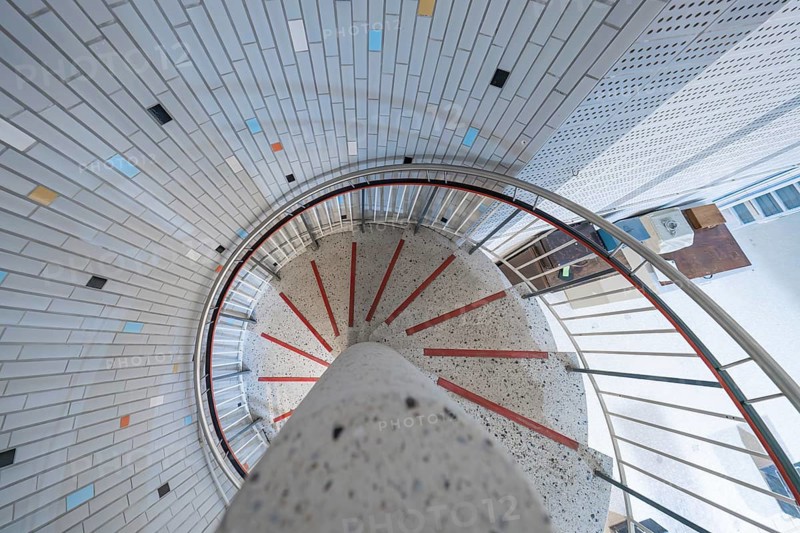 A modern spiral staircase with colourful tiles and bright lighting in a round shape, historical art exhibition in the old swimming pool, Schaudepot, Calw, Black Forest, Germany, Europe