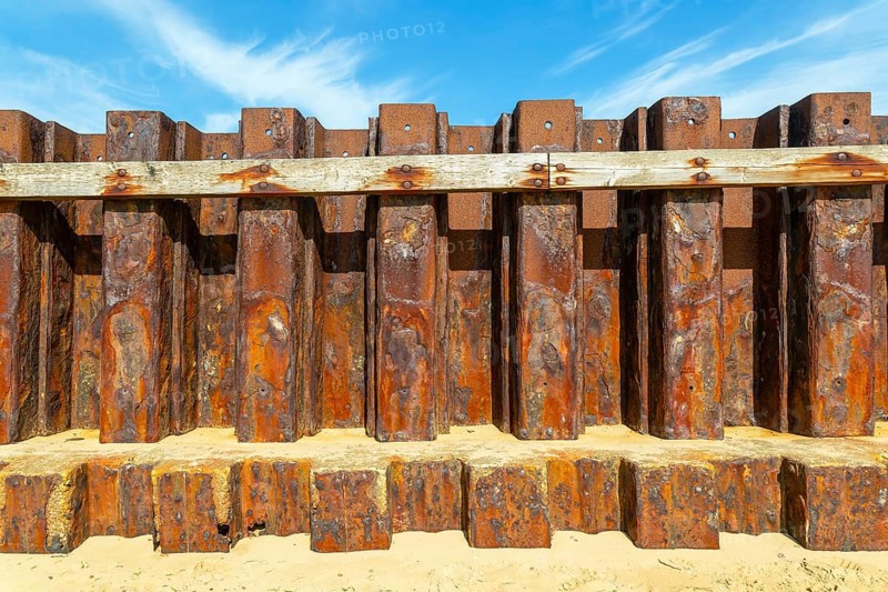 Old rusty steel sheet piling sea wall coastal defence, River Deben, Bawdsey, Suffolk, England, UK