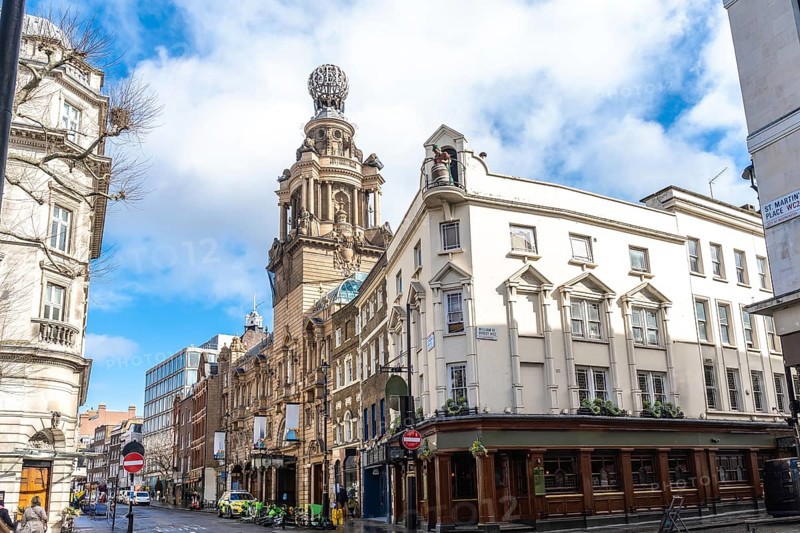 City street view featuring the london coliseum, a historic theatre located in st. Martin's lane, showcasing traditional english architecture
