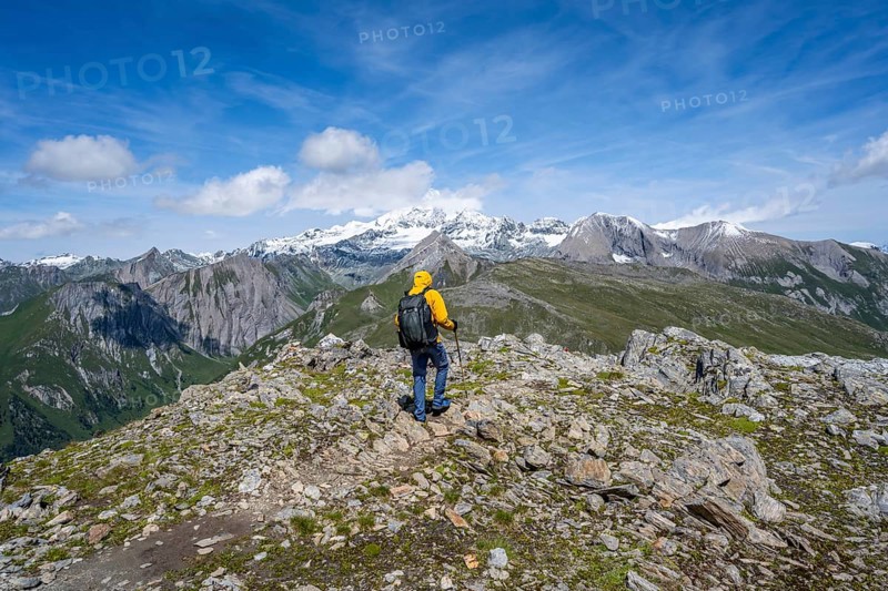 Mountaineers on a hiking trail, view of picturesque mountain landscape with snow-covered summit of the Großglockner, Vienna High Trail, Schober Group, Hohe Tauern National Park, Carinthia, Austria, Europe
