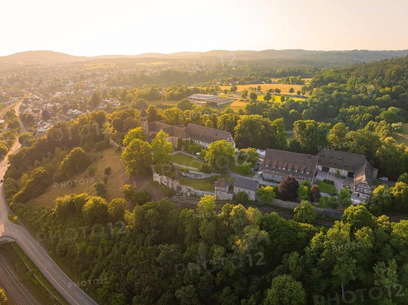 Wide aerial view of a monastery complex in a wooded landscape at sunset, event and wedding location Lorch Monastery, Lorch, Germany, Europe