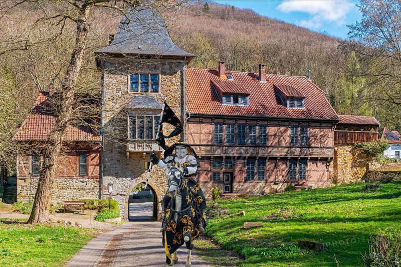 Knight on horseback in front of gatehouse to Schaumburg Germany Composing