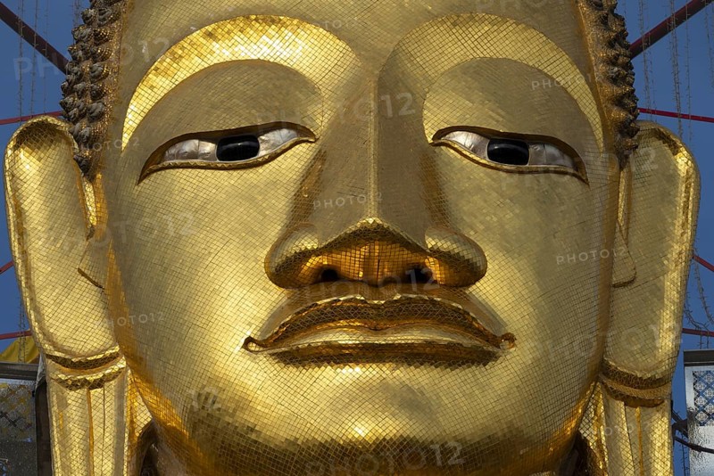 Face of a 32 metre high standing Buddha decorated with glass mosaics and 24-carat gold, Luang Pho To or Phrasiariyametri, Wat Intharawihan, Bangkok, Thailand, Asia