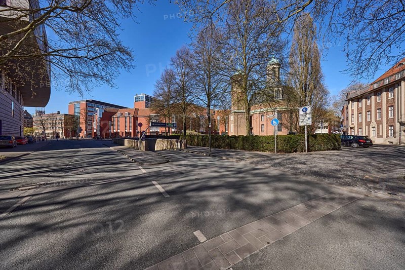 City centre, Clemenskirche, church, baroque architectural style, architect Johann Conrad Schlaun, general architecture, cobblestone street, bare wintry trees, hedge, traffic sign, blue cloudless sky, intersection An der Clemenskirche with Loerstraße, Münster, Münsterland, independent city, North Rhine-Westphalia, Germany, Europe