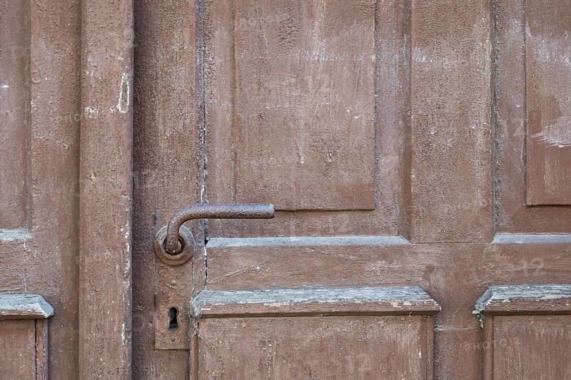 Weathered brown wooden door with rusty door handle and visible texture, Bad Bergzabern, Southern Palatinate, Palatinate, Rhineland-Palatinate, Germany, Europe
