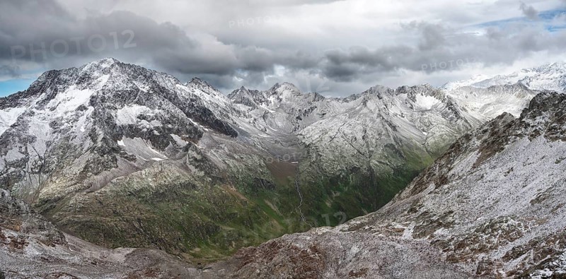 View of steep rocky mountain landscape with fresh snow in summer, in the Hornscharte, on the Wiener Höhenweg, behind summit Roter Knopf, Schober group, Hohe Tauern National Park, Carinthia, Austria, Europe