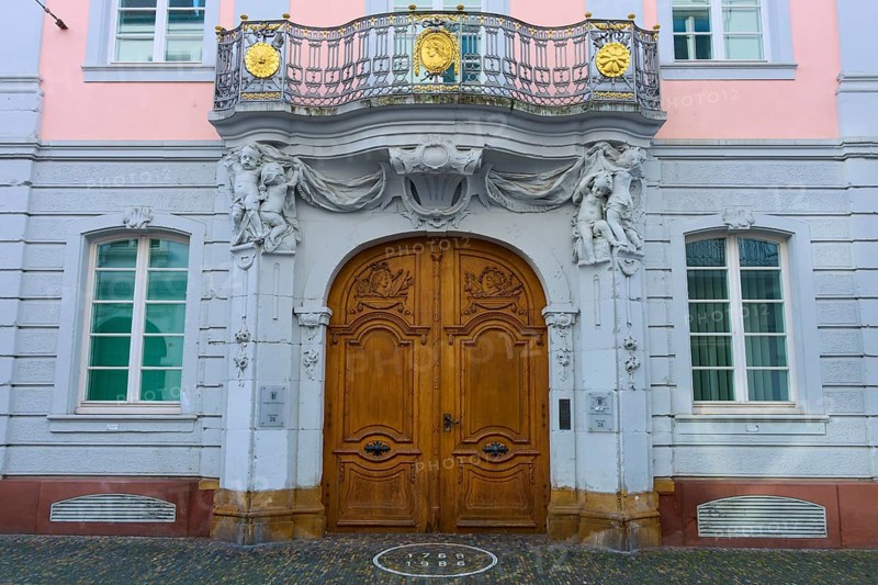 Magnificent wooden door of a pink façade with classical sculptures and decorative details in Baroque style, Freiburg District Court, Freiburg im Breisgau, Black Forest, Baden-Württemberg, Germany, Europe