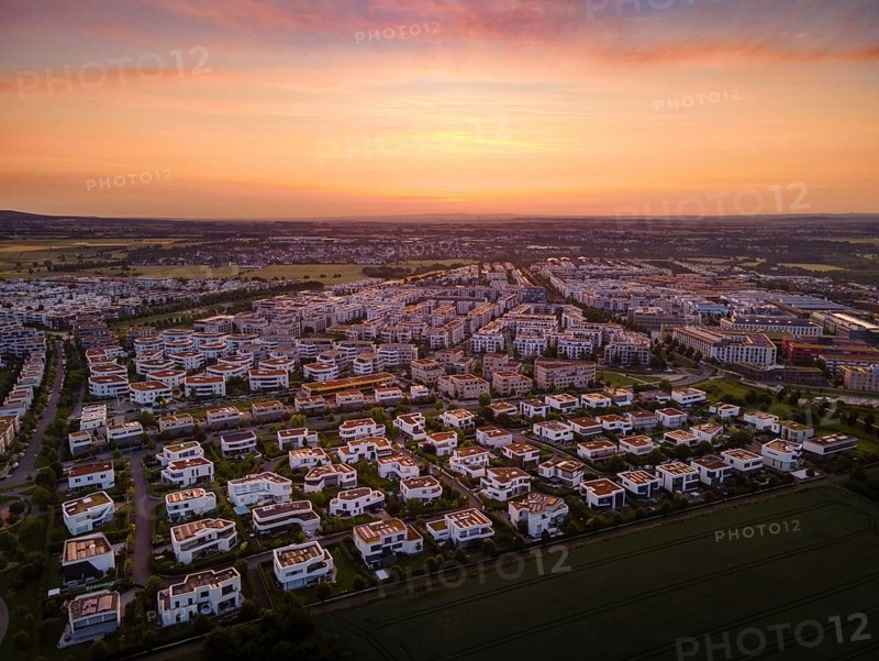 Dawn behind the Riedberg district of Frankfurt heralds the imminent sunrise. (Aerial view with a drone), Germany, Europe