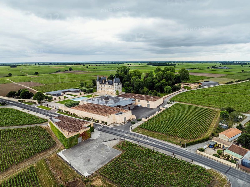Chateau Pichon Longueville Baron Vineyard and grape fields around Pauillac from a drone, Bordeaux, Gironde, Nouvelle-Aquitaine, France, Europe