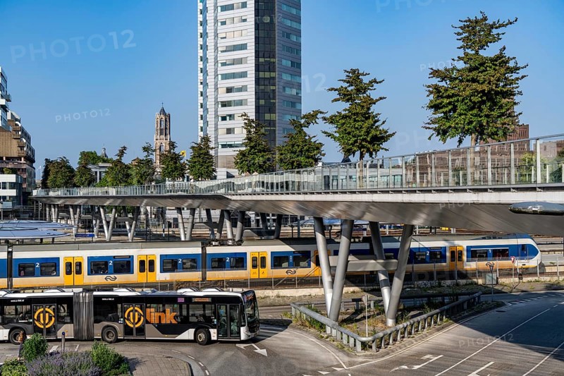 The Moreelsebrug, pedestrian and cycle bridge over the tracks of Utrecht Centraal, Central Station, Greened with trees, Netherlands