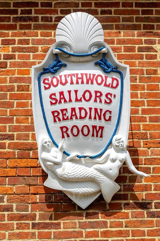 Sign with mermaids on Southwold Sailors Reading Room building, Southwold, Suffolk, England, UK