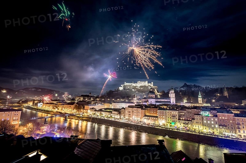 Colorful firework in the night: Old city of Salzburg and Festung Hohensalzburg at New Year?s Eve. Magic