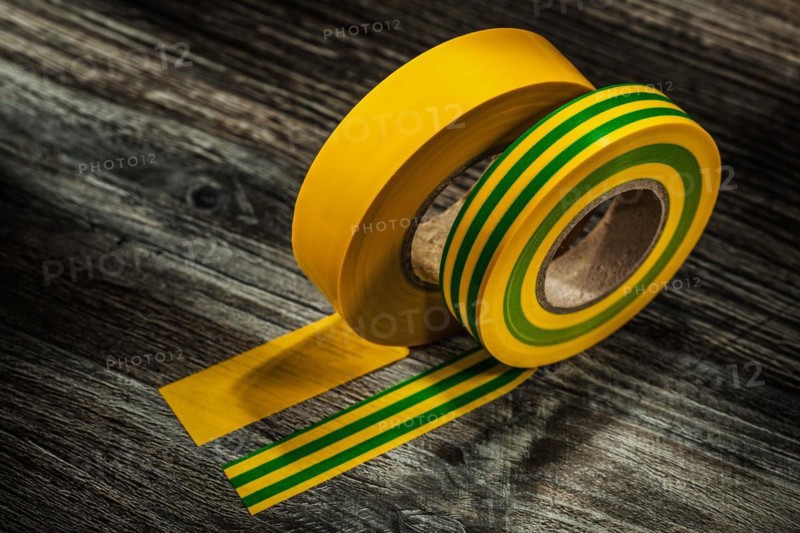 Yellow adhesive tape on wooden board