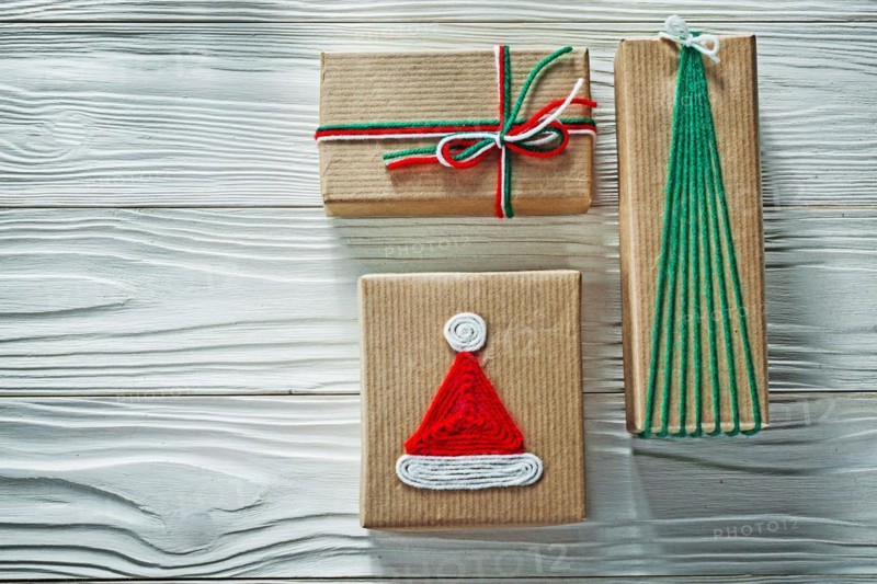 Handmade Christmas gift boxes on wooden board Celebration concept