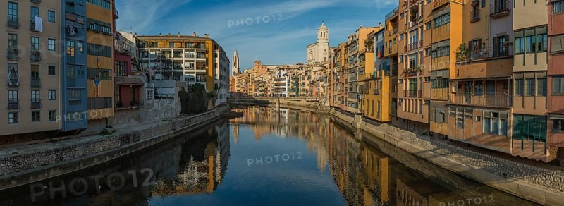 A panorama picture of Girona's Onyar river and its adjacent colorful buildings