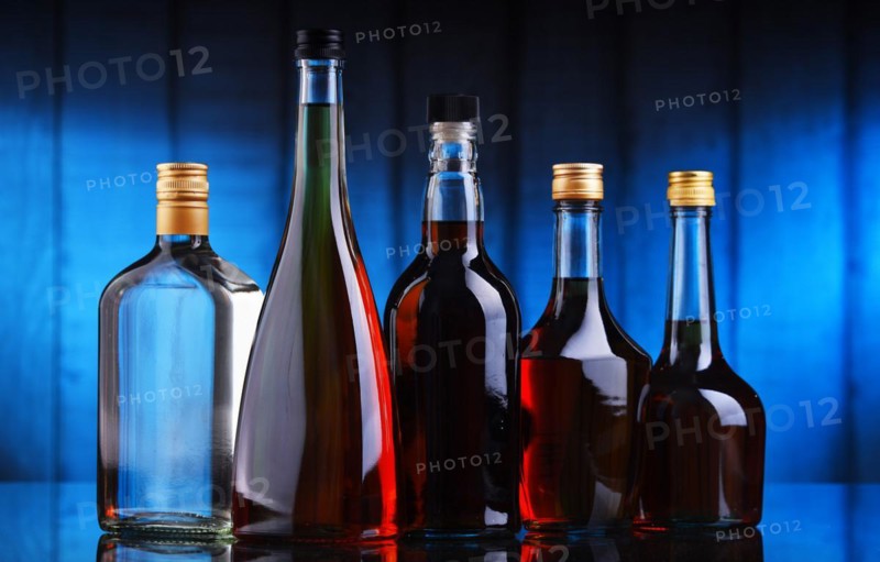 Composition with bottles of assorted alcoholic beverages