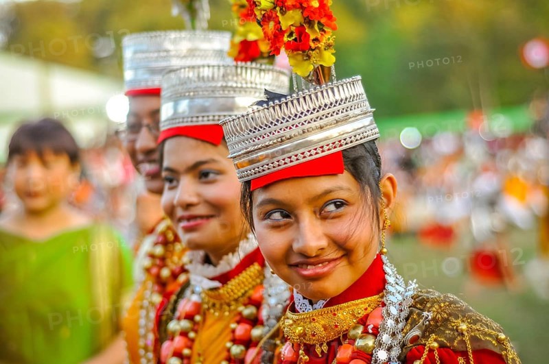 Shillong, Meghalaya, circa April 2012: Smiling girls in traditional costumes with large beads and crowns on their heads at Shad Suk Mynsiem Festival in Shillong, Meghalaya. Documentary editorial
