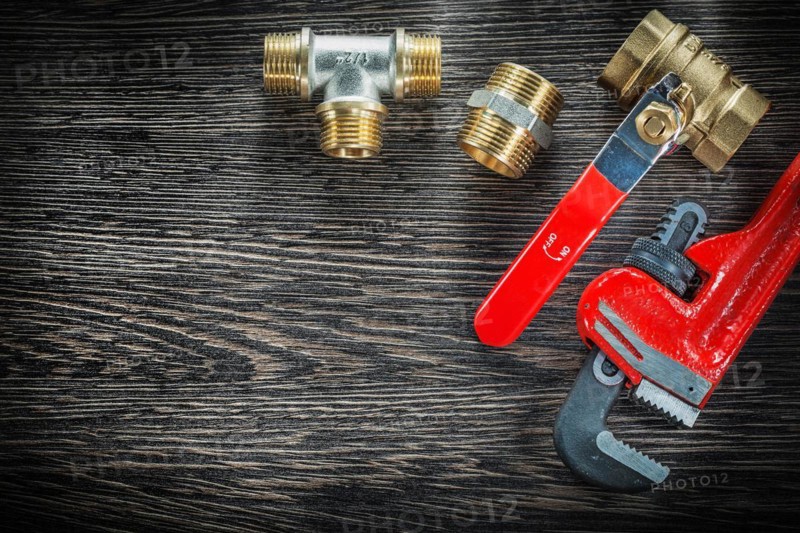Sanitary monkey spanner connections water valve on vintage wooden board