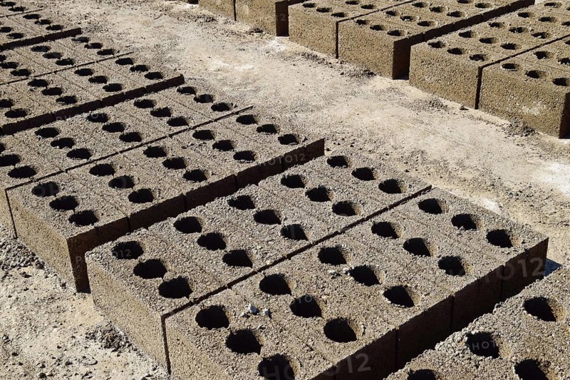 Freshly made cinder blocks on a concrete pad