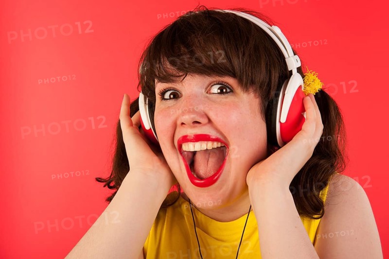 Young woman is exciting about hearing good music
