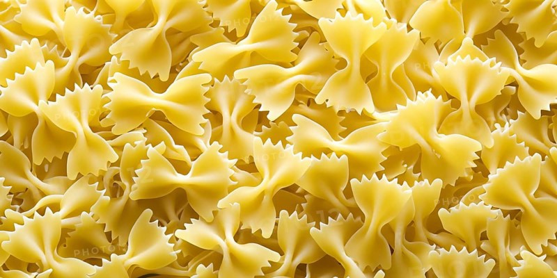 Pasta in the form of butterflies scattered in the background image