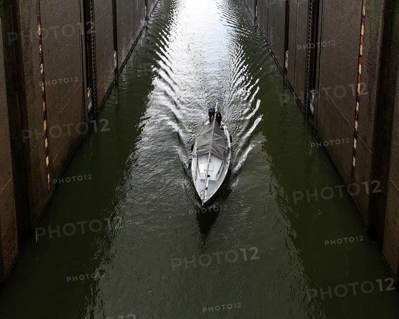 Maasbracht, Limburg, The Netherlands, 04 20 2022, Large sluice gate with a small vessel passing by, Europe