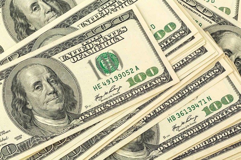 Many American dollar banknotes. Symbolic photo for debt and wealth Austria