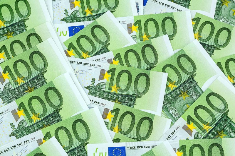 Many one hundred euro banknotes lying next to each other. Symbolic photo for wealth and investment