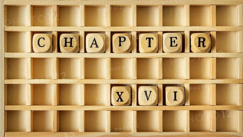 An image of a wooden game with the word chapter sixteen