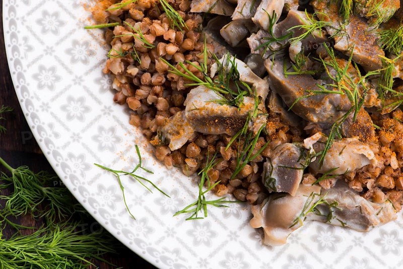 Stewed turkey stomachs with vegetables and buckwheat in a bowl