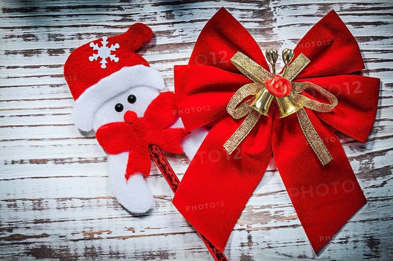 Santa Claus toy red bow on vintage wooden board celebrations concept