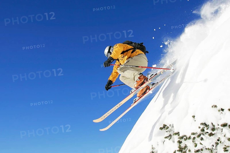 Skiers in action, skiing down the slope