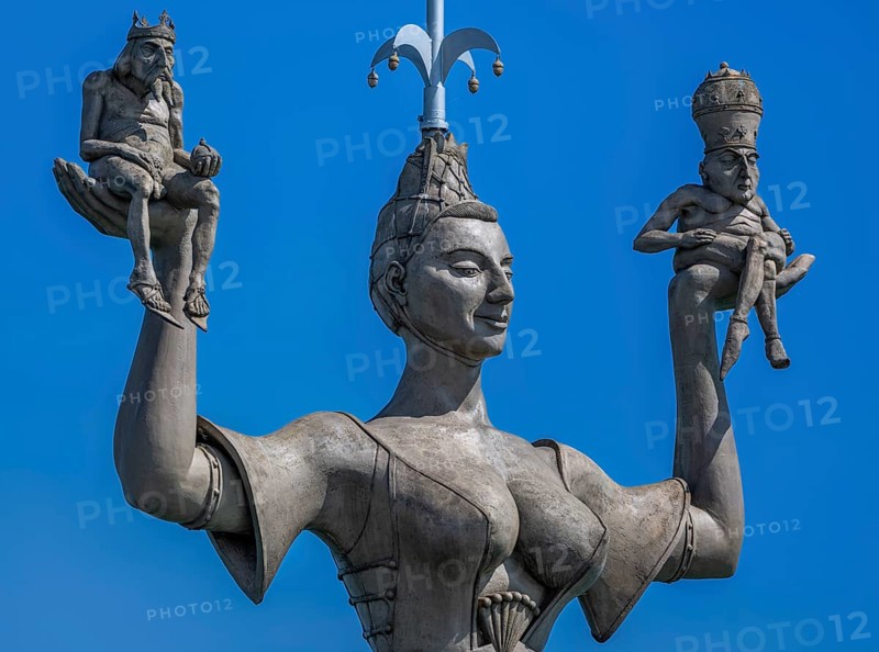 Imperia, a rotating, nine metre high concrete statue in the port of Constance, designed by Peter Link. The statue is a satirical reminder of the Council of Constance (1414-1418) . On her raised hands, the imperialist carries two small naked men, in her right hand a king with crown and orb, in her left hand a man with a papal tiara and crossed legs, Constance, Baden-Württemberg, Germany, Europe