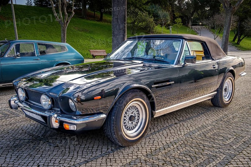 Lisbon, Portugal, Jan 20, 2024: Classic brown Aston Martin V8 Volante grand tourer parked on a cobblestone road, know as Britain first supercar, 2-door coupe convertible, Europe