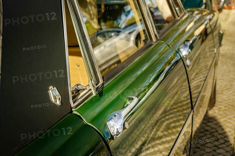Lisbon, Portugal, Jan 20, 2024: Details of side view of classic green Rover P6 Series II or Mark II 2000 TC executive car, 4 door saloon, parked on a cobblestone path in a city. Doors, handles, emblem and open quarter window in selective focus, Europe
