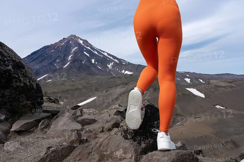 Closeup woman in figure hugging sports leggings showing off buttocks and legs. Athletic woman doing outdoor fitness training and her gluteal and thigh muscles are clearly defined. Rear view of body