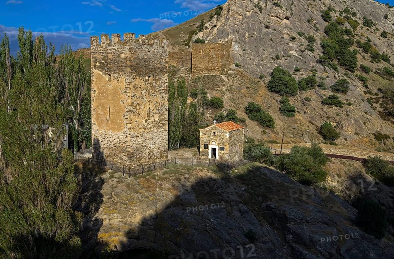 Medieval tower and old Christian temple near the ruins of the Genoese fortress in Sudak, Crimea