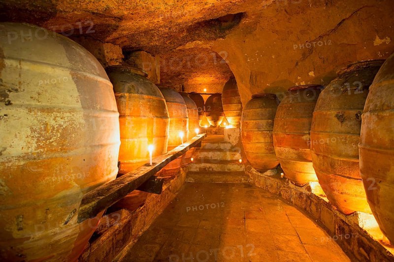 Antique winery in Spain with clay vessels terracotta amphora pots Mediterranean tradition with candlelight