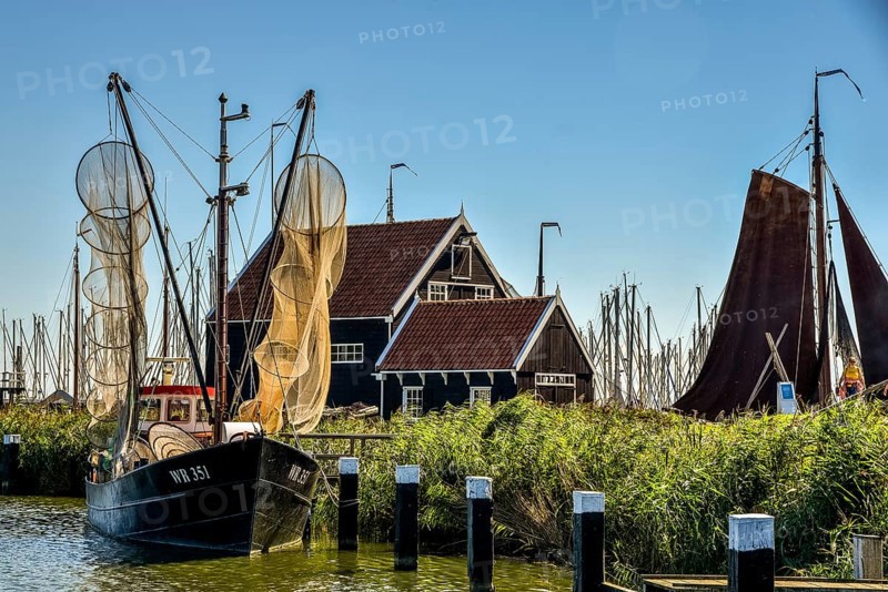 Enkhuizen, the Netherlands, September 2020. The Zuiderzeemuseum, an open air museum at the shore of the IJsselmeer with traditional Dutch fishermen cottages and flat bottomed fishing boats.