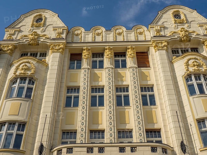 Historic building with ornate façade, stucco work and gilded elements under a blue sky, bratislava, slovakia