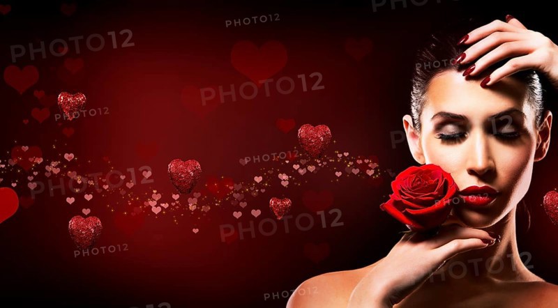 Beautiful woman with dramatic makeup and red lips. Red flower rose. Hearts in the background, Toronto, Canada, North America