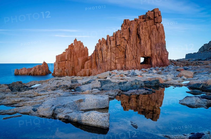 A view of the red rocks of Arbatax with reflections in tidal pools in the foreground
