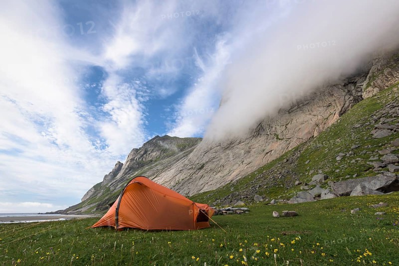 Tent at the foot of a rock face, Buneset, Moskenesöya, Lofoten, Nordland, Norway, July 2015, Europe