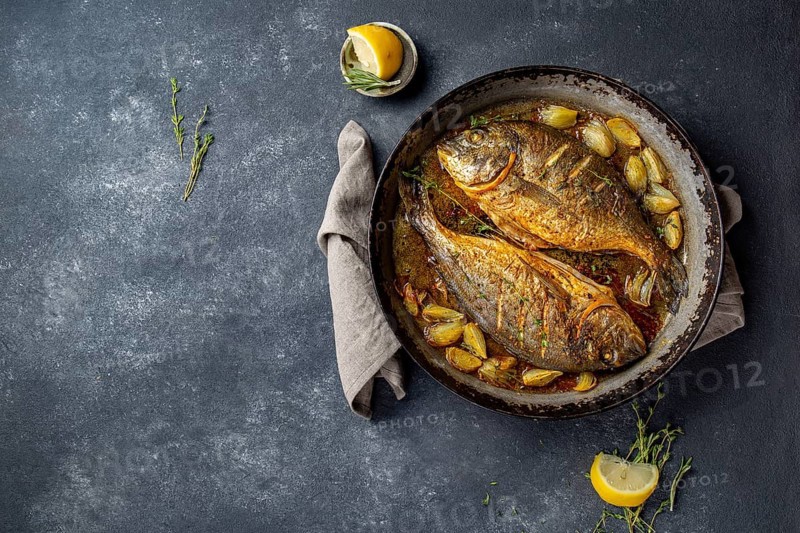 Food, Food, Baked sea bream or dorada with onion and herbs in pan on dark background