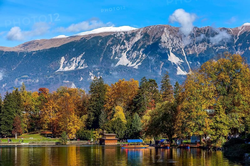 Bled, Slovenia panoramic sunset view of Lake and autumn colorful trees background in julian alps mountains