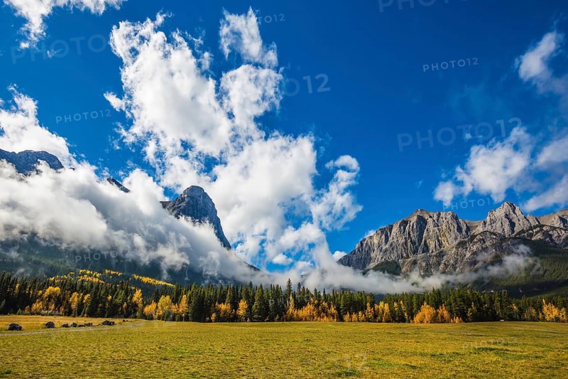 Concept of hiking. Auroral sunny day in Canmore. The famous Three Sisters mountains in the Canadian Rockies of Canada