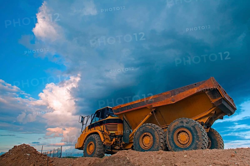 Yellow mining truck at work site before heavy storm