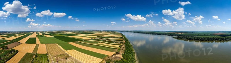 Aerial panorama of colorful fields on high bank of Danube river in Serbia